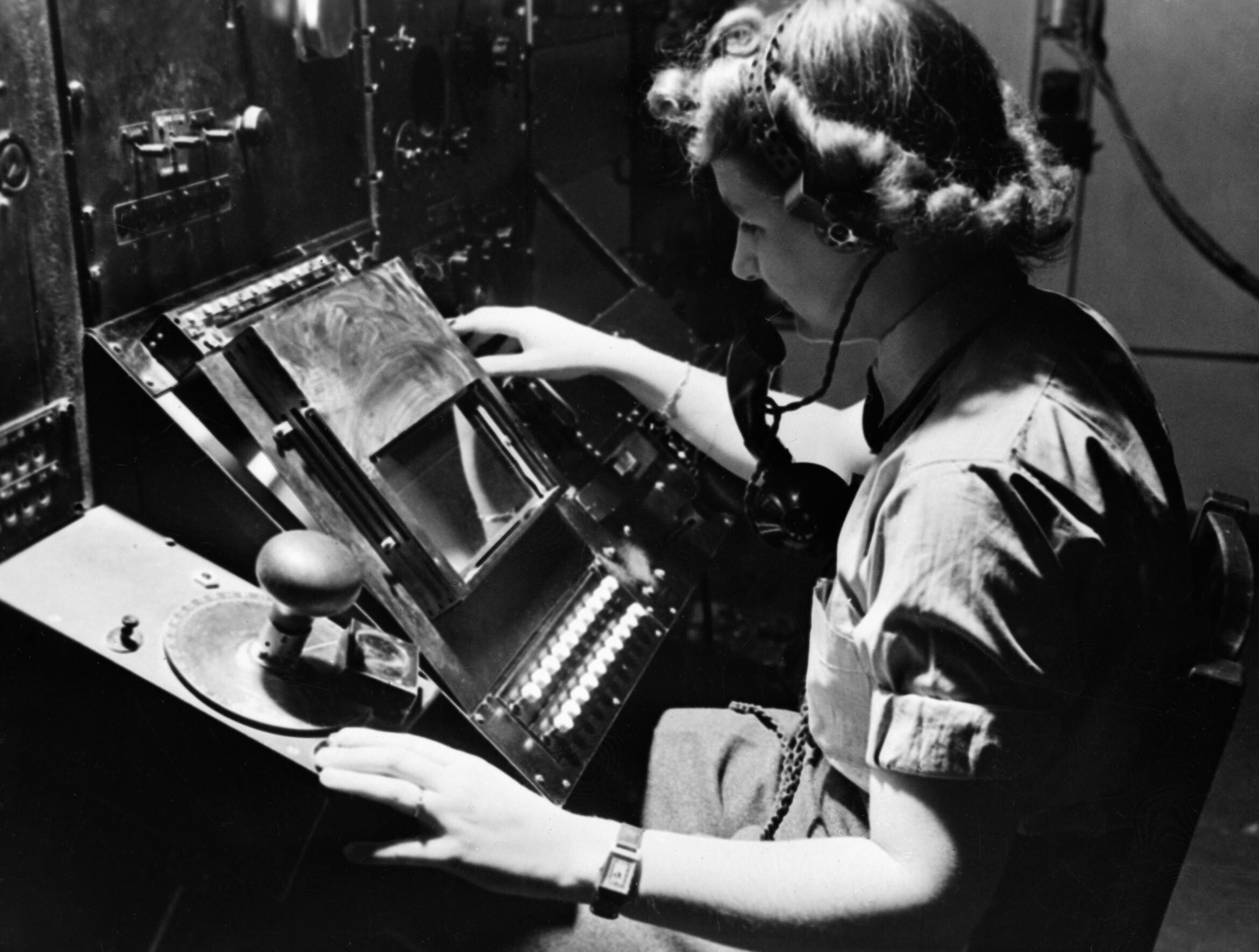 WAAF_radar_operator_Denise_Miley_plotting_aircraft_on_a_cathode_ray_tube_in_the_Receiver_Room_at_Bawdsey_Chain_Home_station_May_1945._CH15332